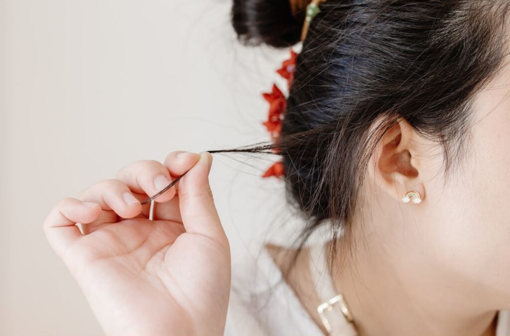 Woman pulls on her hair