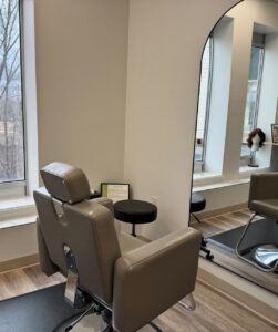 photo of salon chair in front of curved mirror in consultation room