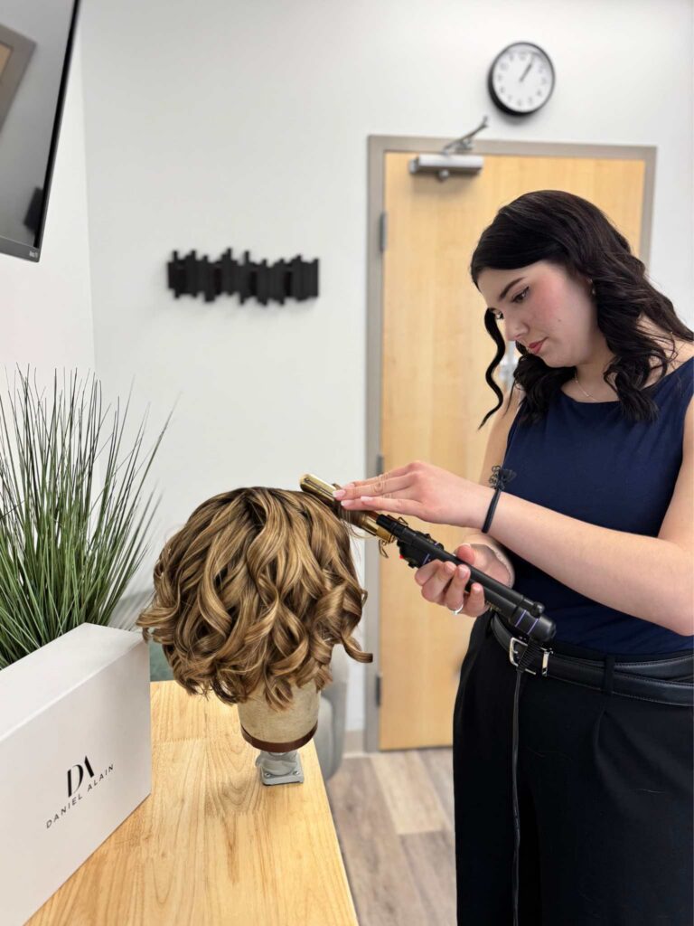 Amanda curling a human hair wig